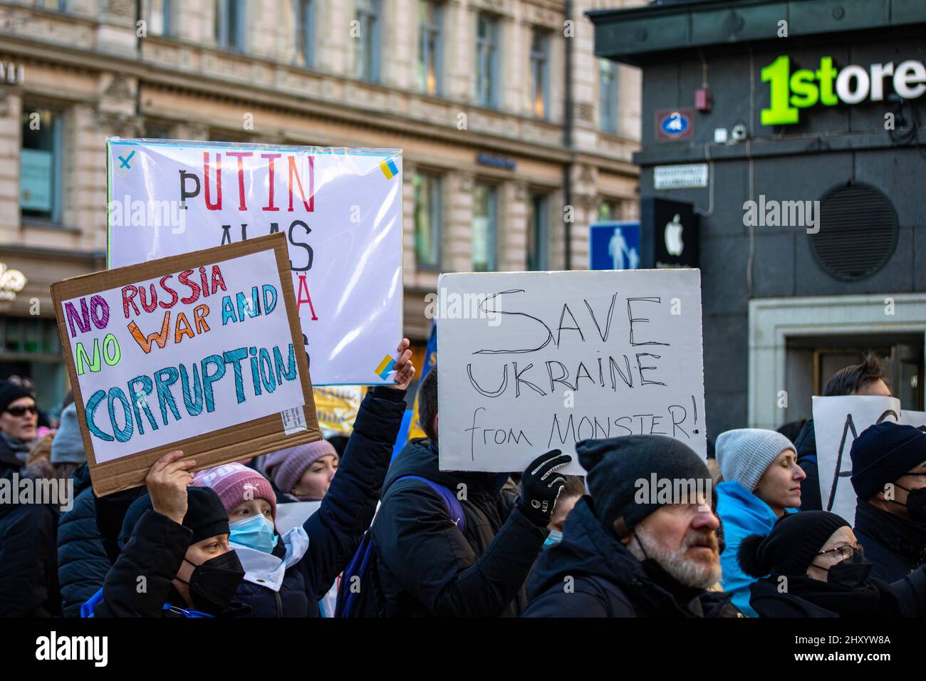 Demostrators with signs at protest against Russian invasion of Ukraine on Aleksanterinkatu in Helsinki, Finland Stock Photo