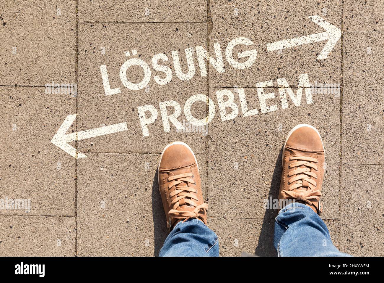Closeup of shoes with arrows and german text Losung Problem, in English solution problem Stock Photo