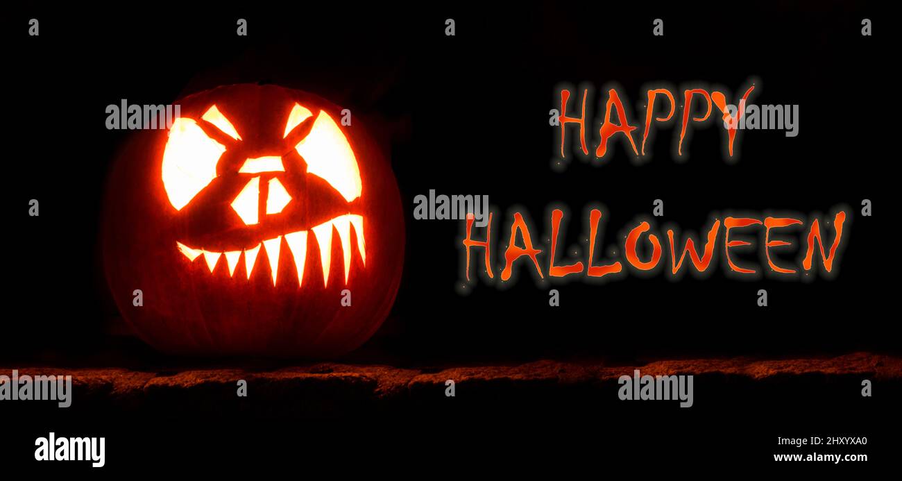 Dark background of Halloween pumpkin with horror face Stock Photo - Alamy