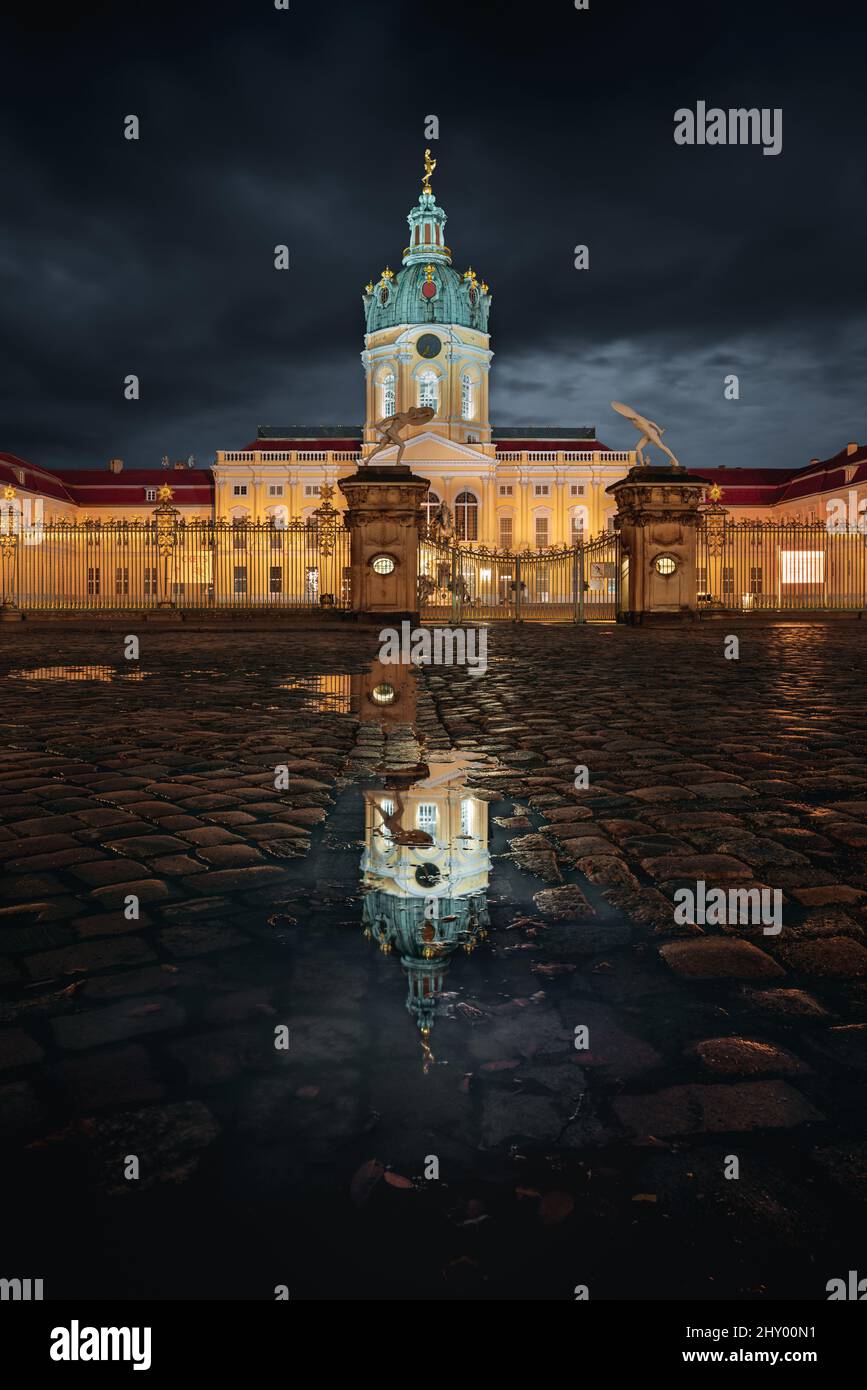 Berlin Castle with the reflection on the wet ground at night Stock Photo