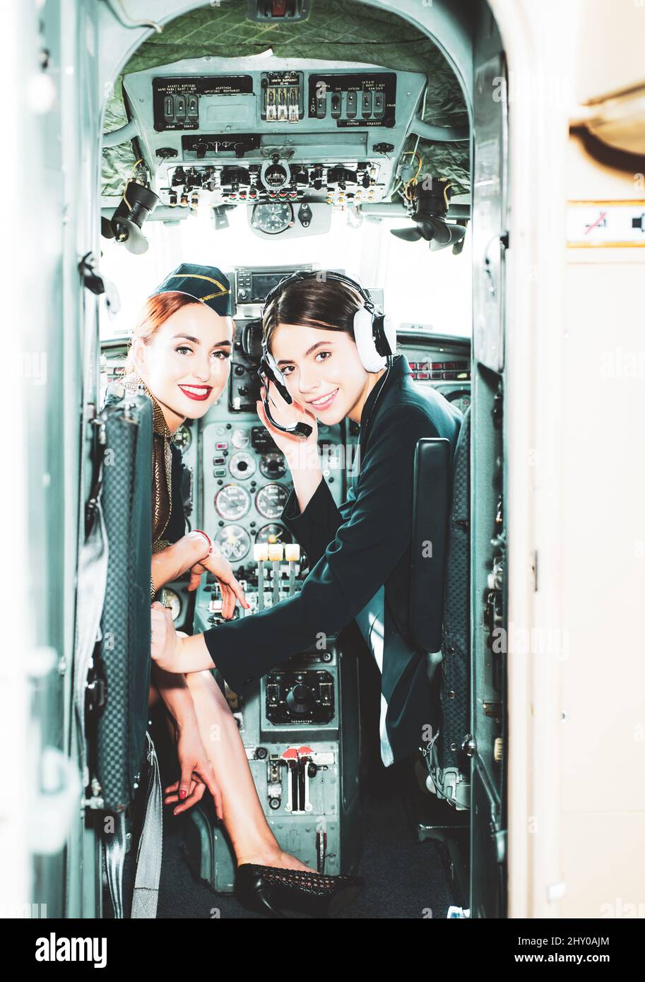 Two young girls in aircraft. Young Woman Pilot With Headset. Beautiful ...