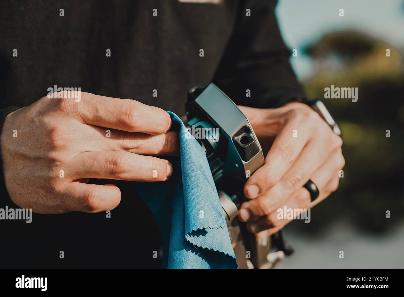 Closeup of man's hands wiping the vintage camera's lens Stock Photo Alamy