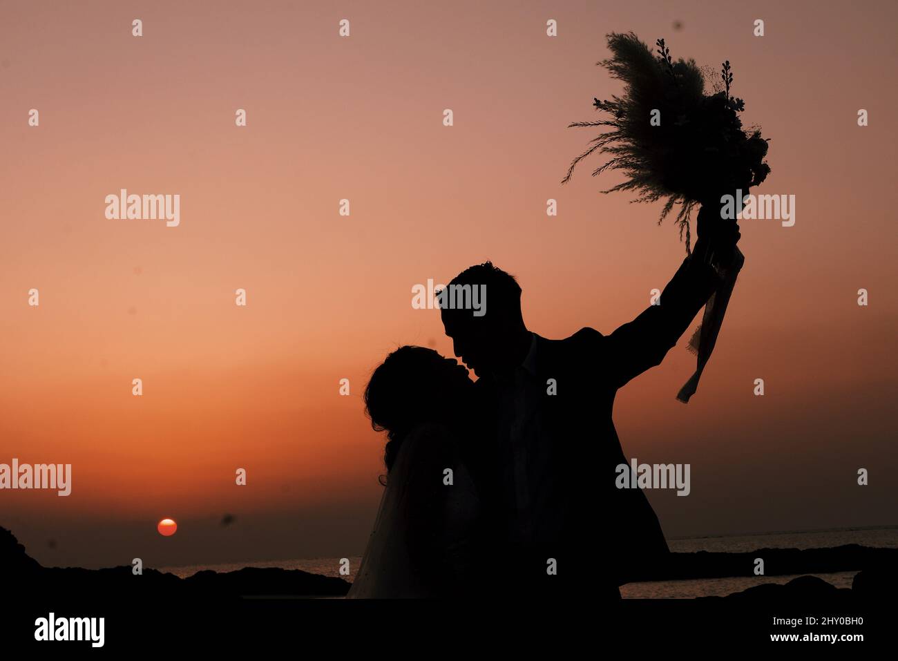 Silhouette of a couple kissing during the sunset Stock Photo - Alamy