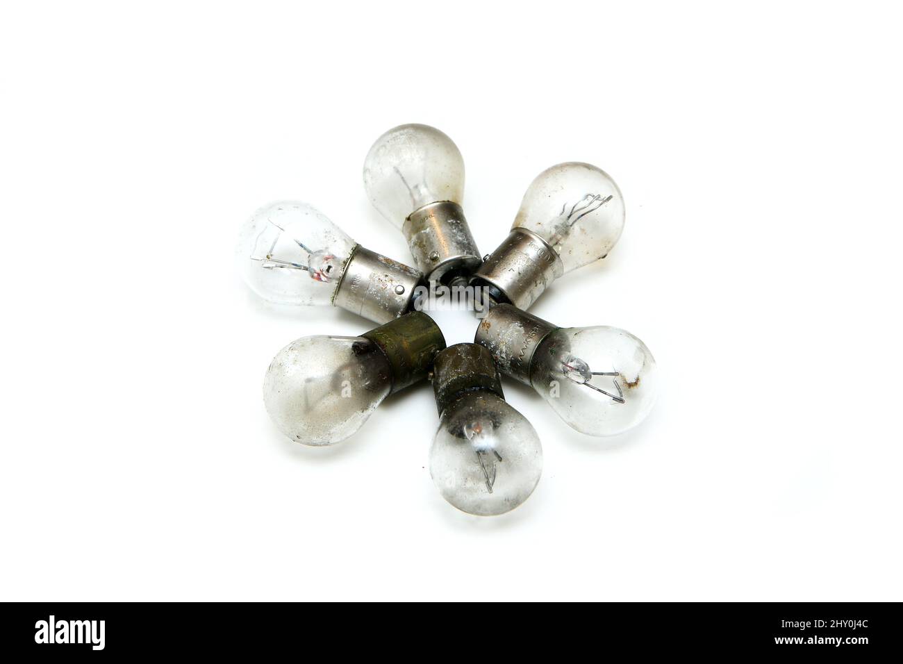 The small group of old shabby small bulbs for the car lights isolated in the white background. Stock Photo