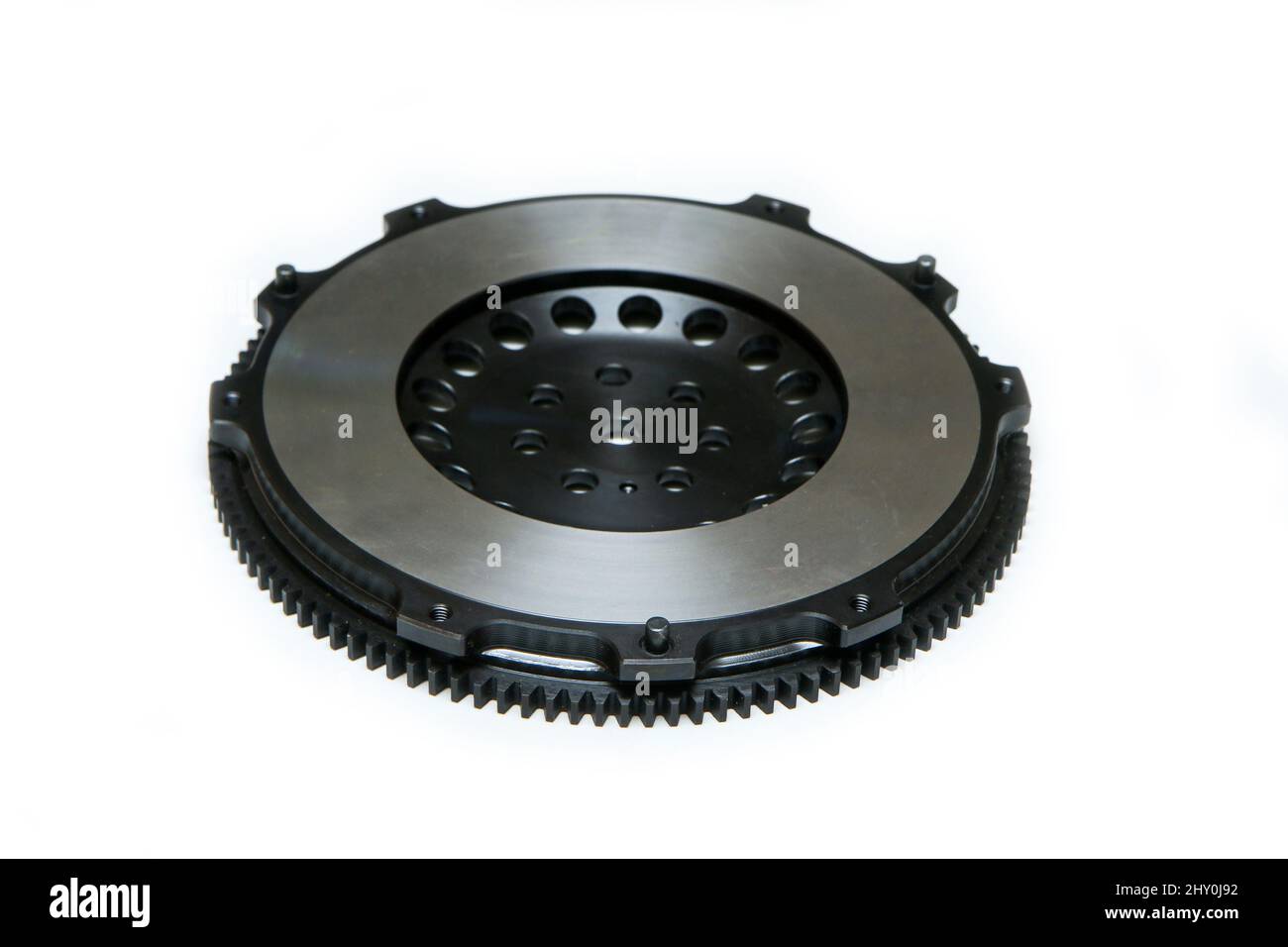 The shiny new lightweight engine flywheel isolated in a white background. Stock Photo