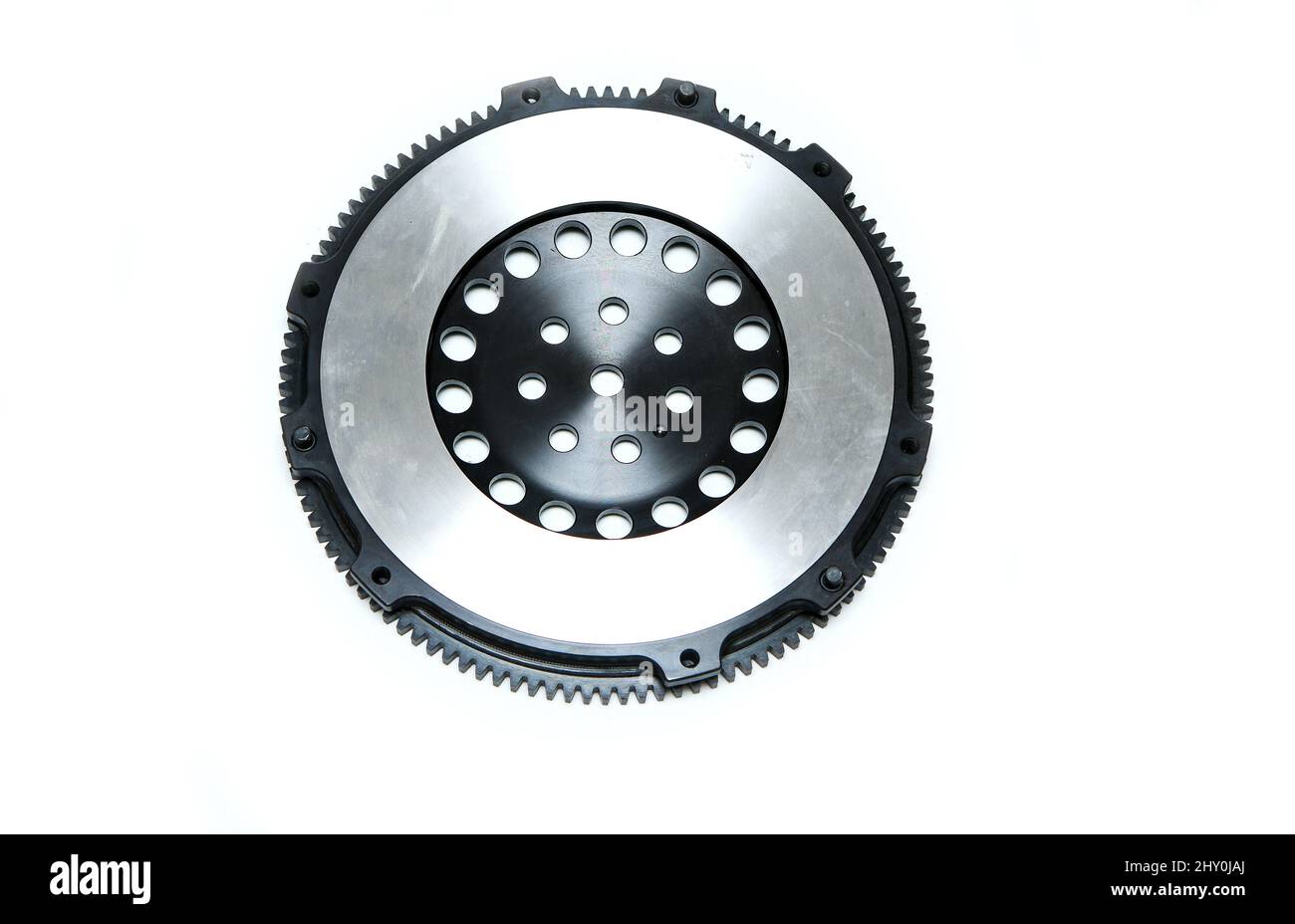 The shiny new lightweight engine flywheel isolated in a white background. Stock Photo