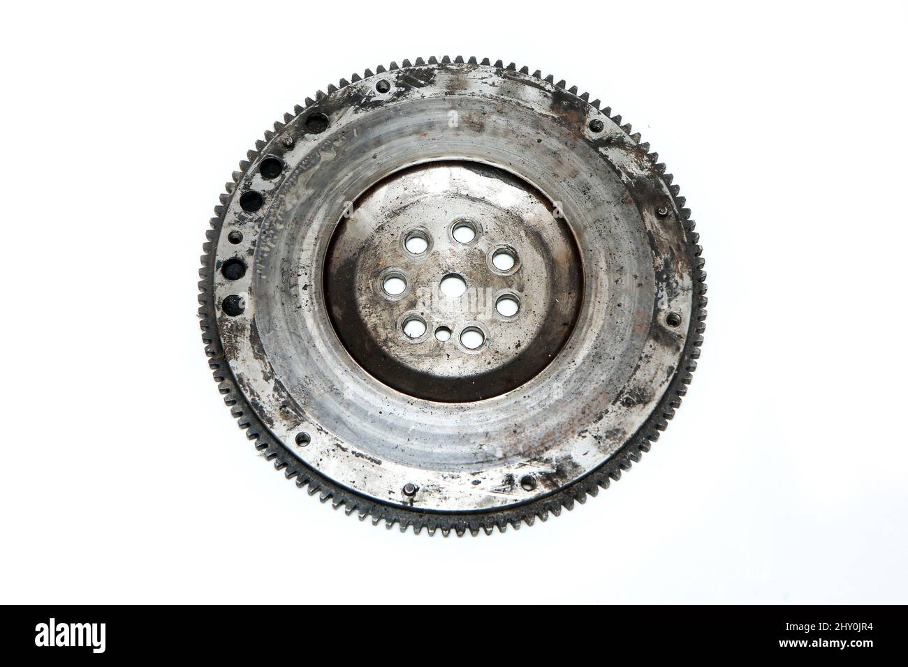 The rusty old used engine flywheel isolated in a white background. Stock Photo