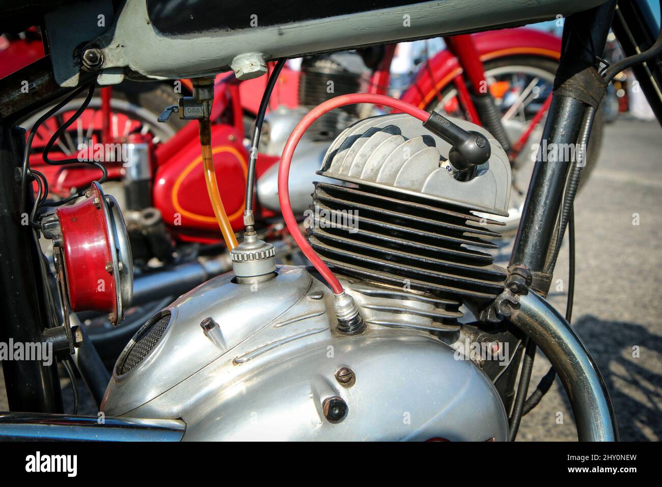 The detail of the polished old motorbike with the two stroke engine. The head has ribbing and is air cooled. Stock Photo