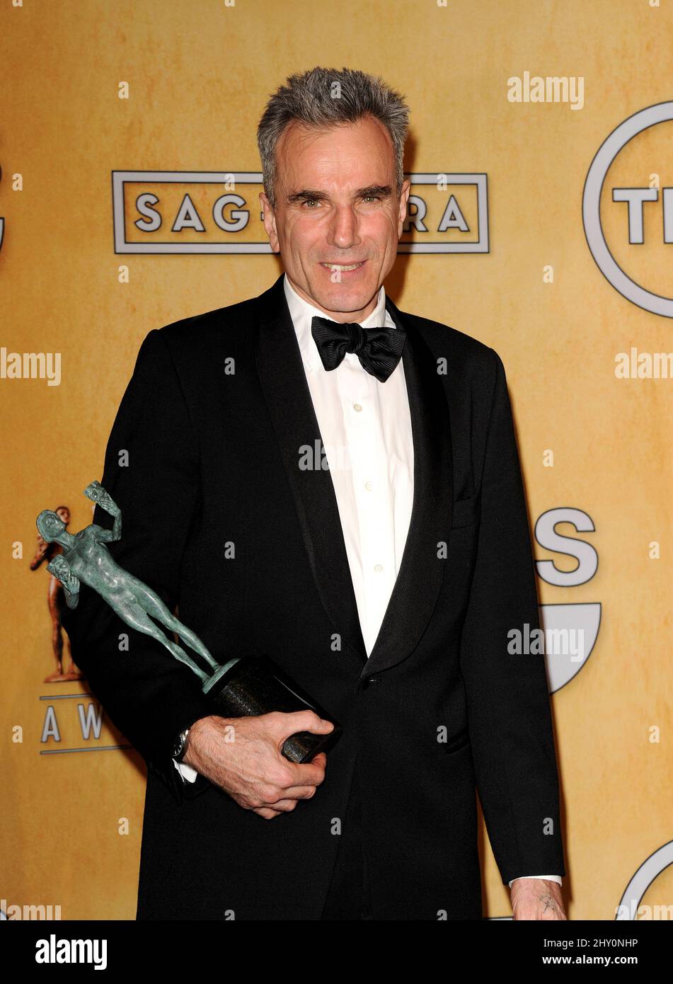 Actor Daniel DayLewis poses backstage with the award for best male