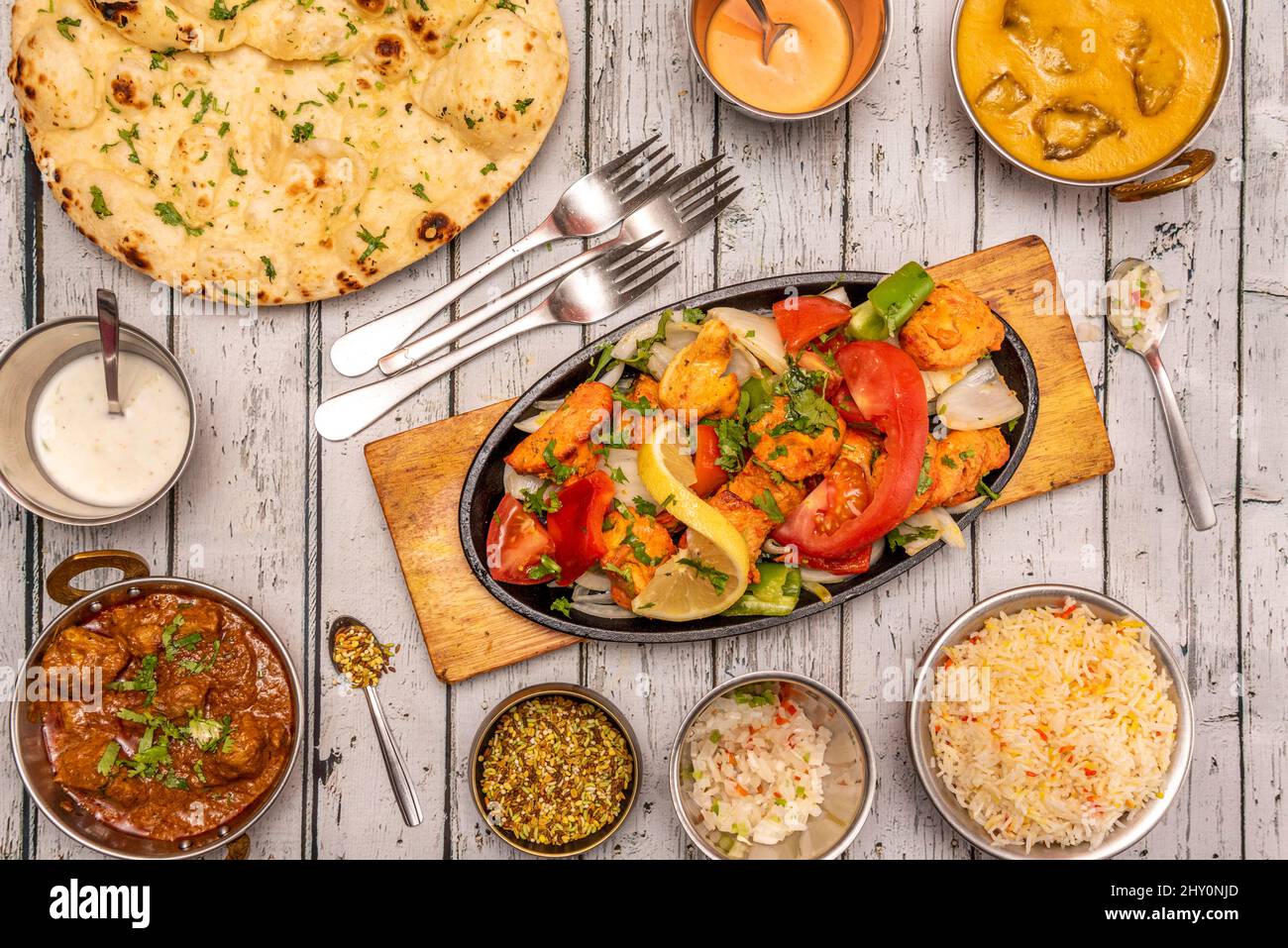 Set of cute Indian food dishes with spicy curry, braised chicken tikka