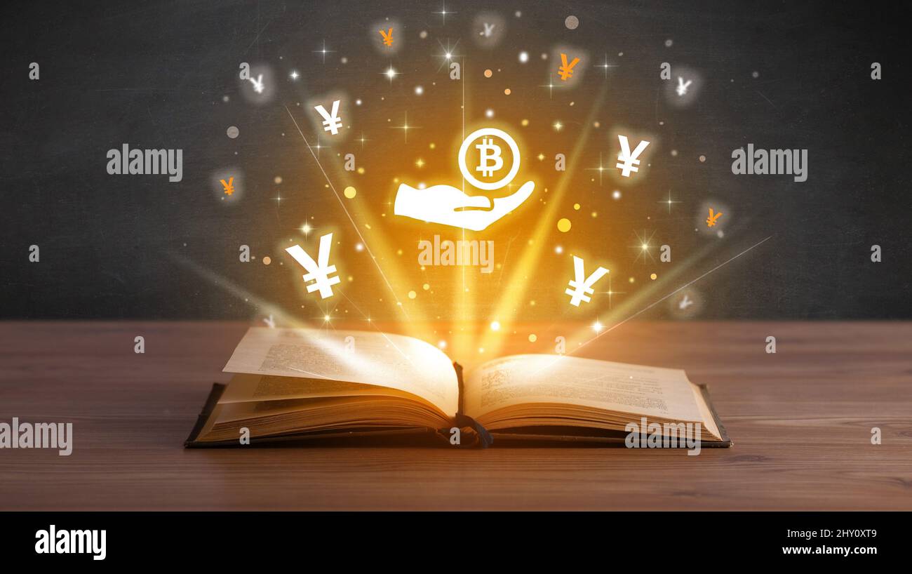 Open book with currency icons above Stock Photo - Alamy