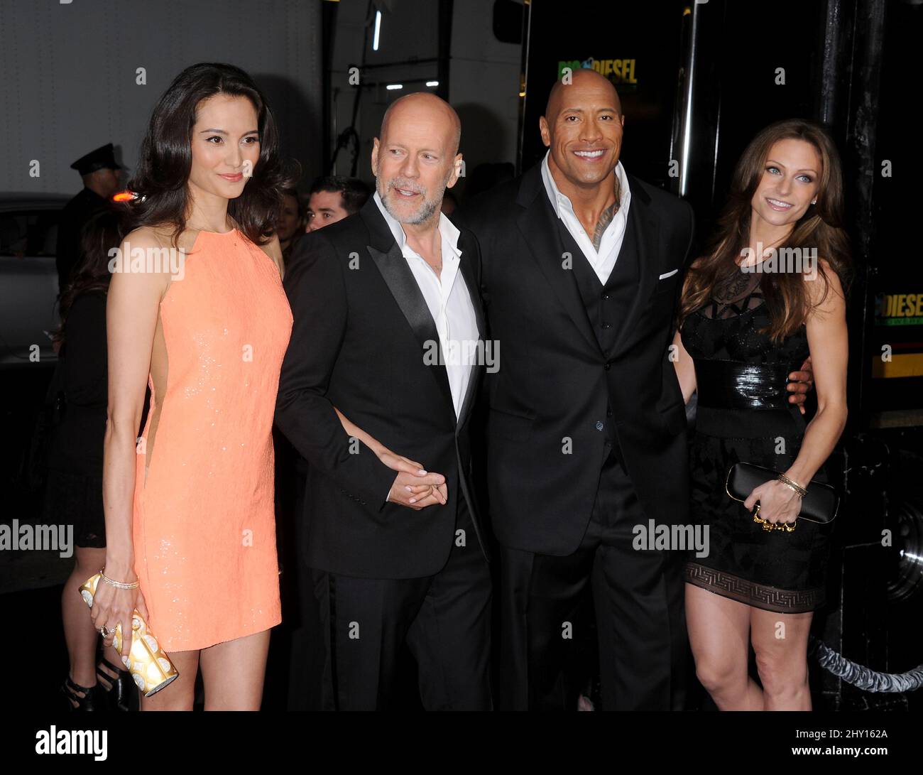 Emma Heming, Bruce Willis, Dwayne Johnson, Lauren Hashian during the premiere of the new movie from Paramount Pictures G.I. JOE: RETALIATION, held at Grauman's Chinese Theatre, on March 28, 2013, in Los Angeles. Stock Photo
