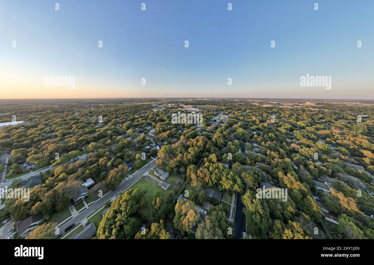 Aerial view of a cityscape with lot of green trees at the sunset Stock ...