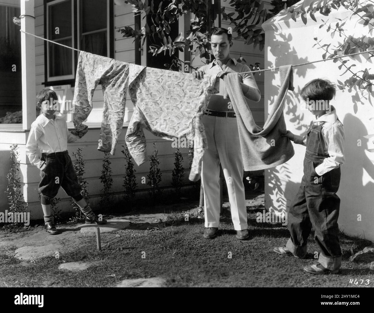Buster Keaton with his two sons, Joseph and Robert, hanging laundry