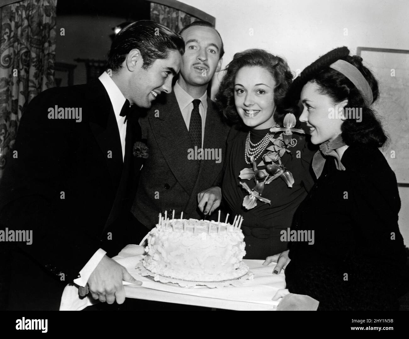 Tyrone Power, David Niven, Virginia Fields and Maureen O'Sullivan at a party for Virginia Fields. circa1945File Reference # 34145-705THA Stock Photo