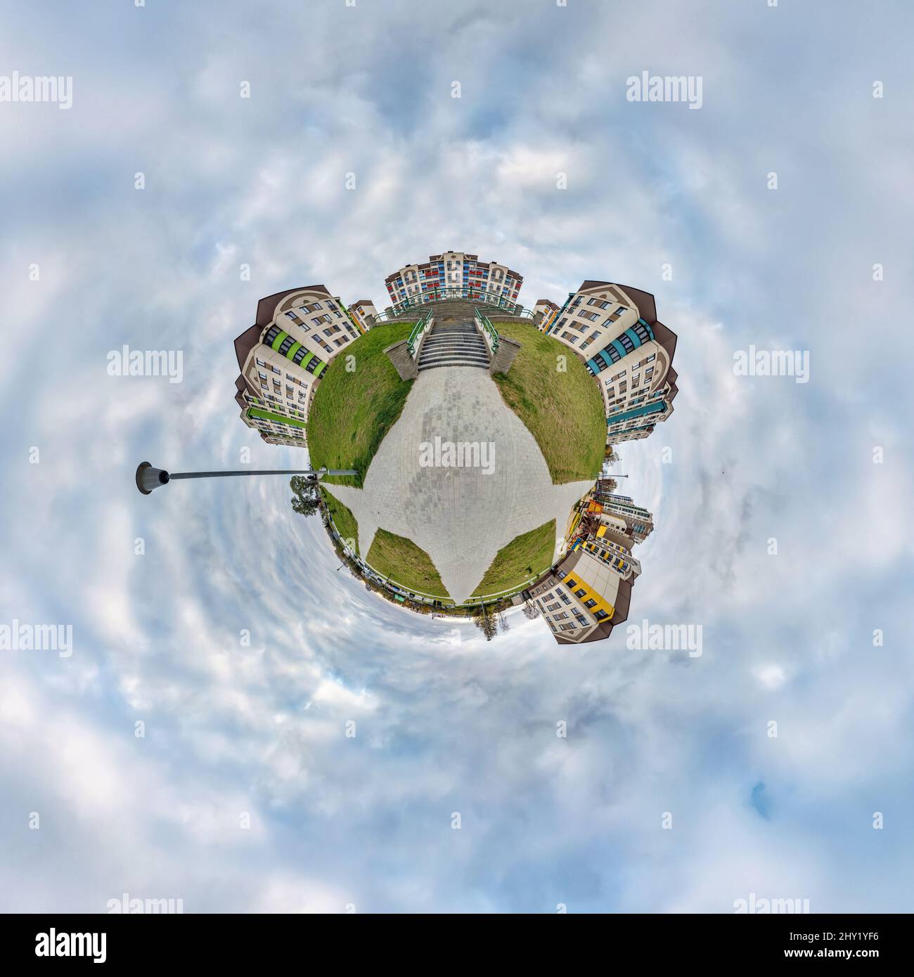 tiny planet in sky with clouds in modern multi-storey multi-apartment ...