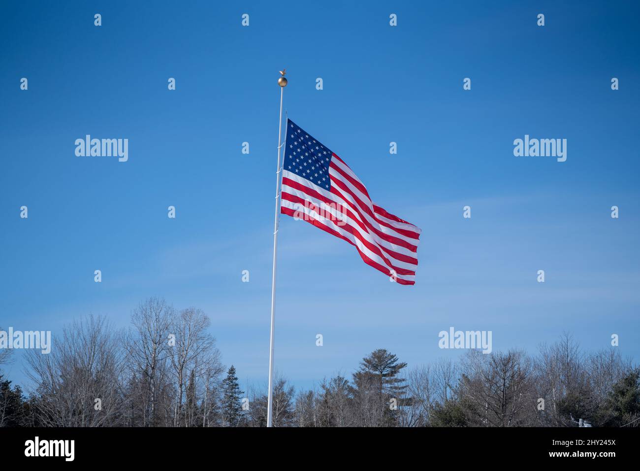 Shot of the American flag against the blue sky Stock Photo - Alamy