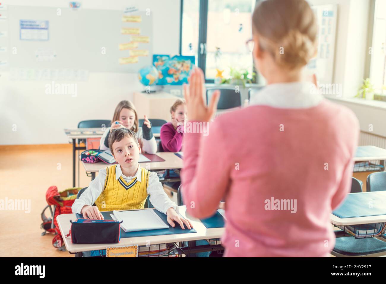 Teacher with her students in class at elementary school Stock Photo