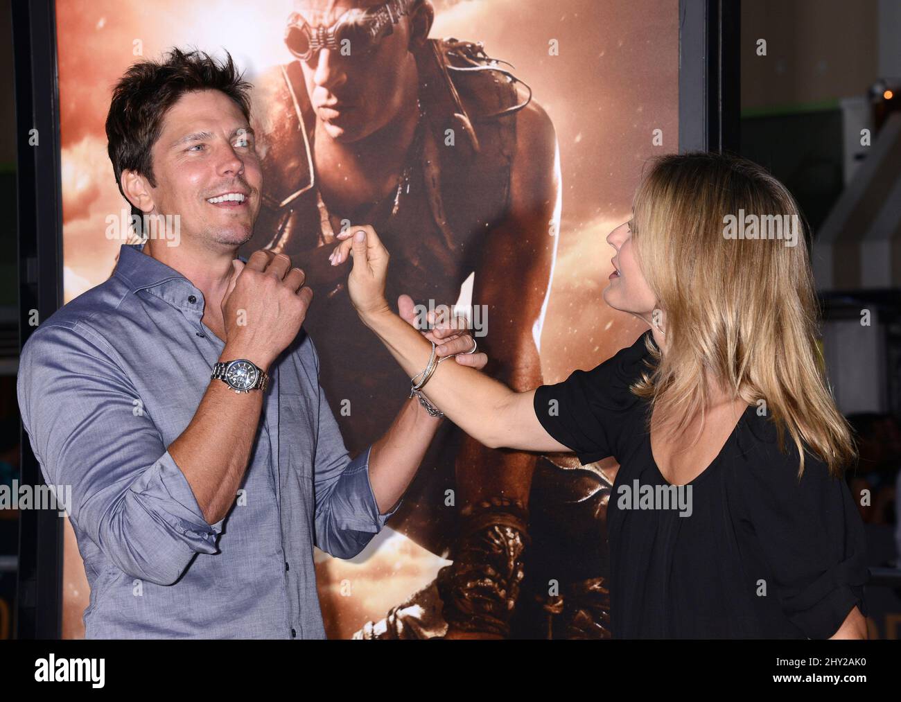 Michael Trucco and Sandra Hess attends as Universal Pictures presents the World Premiere of 'Riddick' at The Westwood Village Theater in Los Angeles. Stock Photo