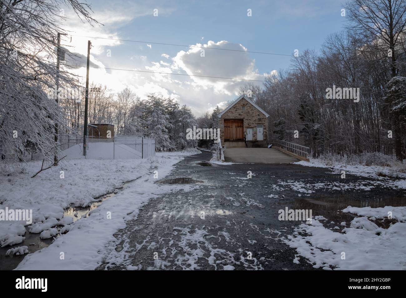 Winter house on gravel path in woods Stock Photo