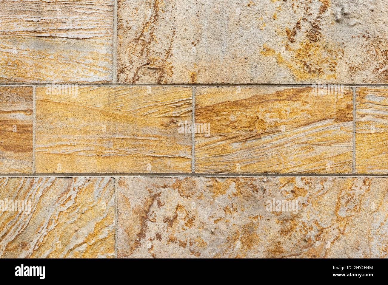 Geologic crossbedding features visible in detail shot of architectural sandstone building blocks on a wall Stock Photo