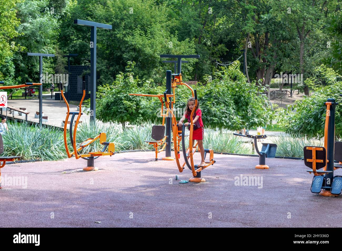 KHARKIV, UKRAINE - AUGUST 3, 2021: An unidentified girl on a sport ground for children in the Sarzhin Yar city park. Stock Photo