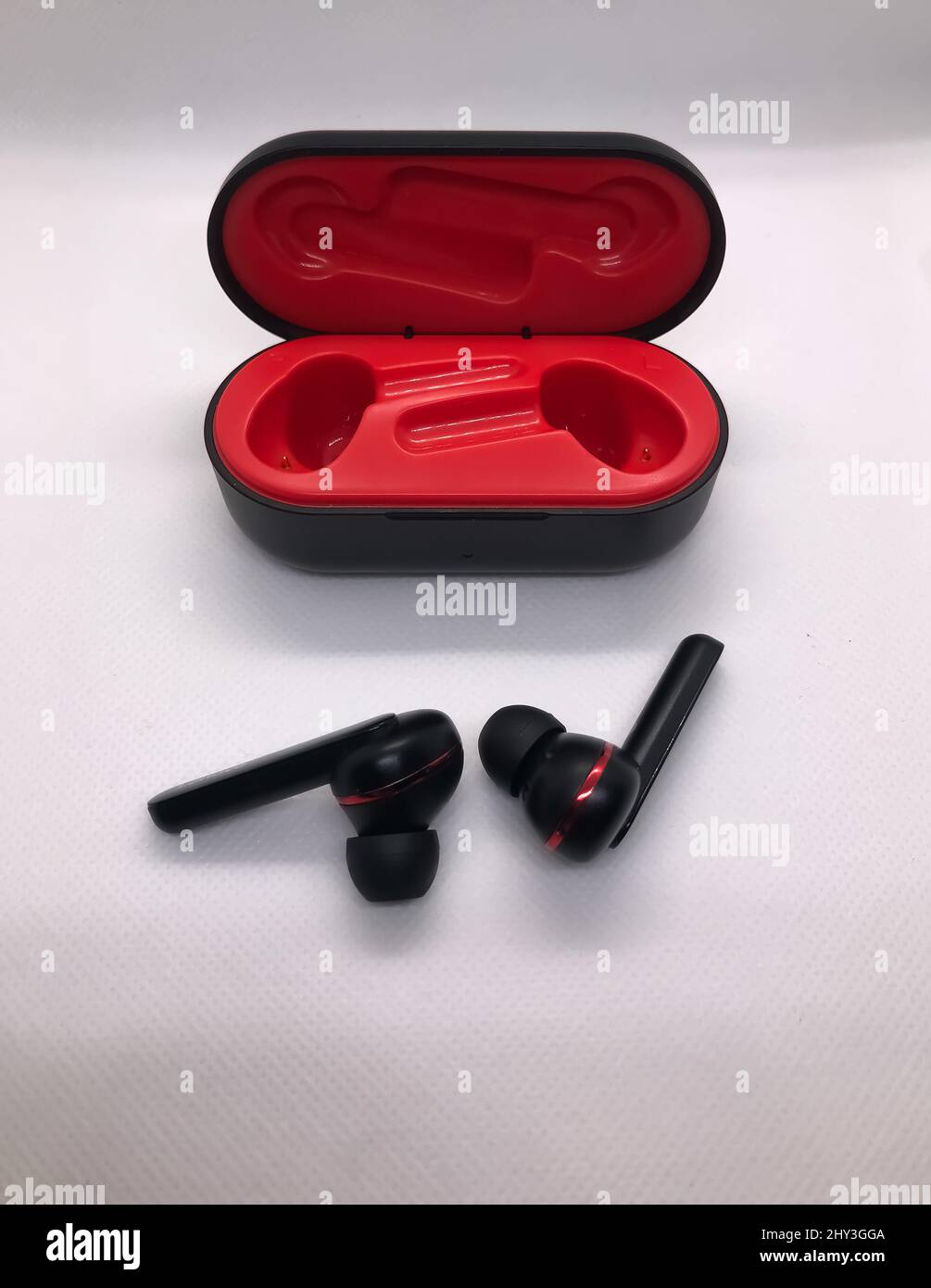 Red and black wireless headphones on white background Stock Photo - Alamy