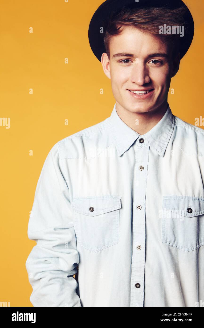 Happy to be me. Portrait of a young man wearing a hat and smiling widely at the camera. Stock Photo