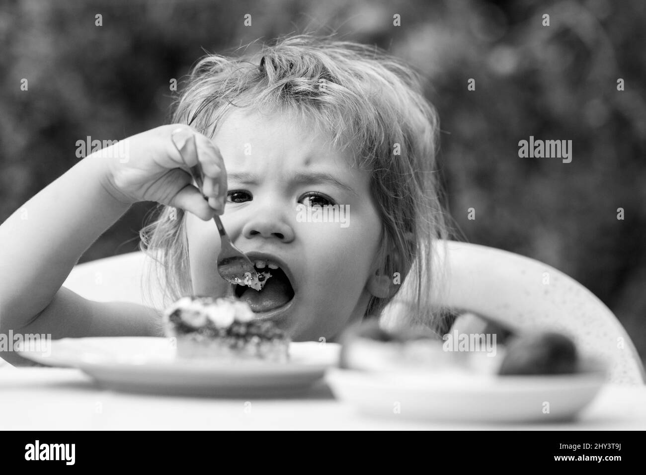 Baby eating cake. Child eat cupcake outdoors Stock Photo - Alamy