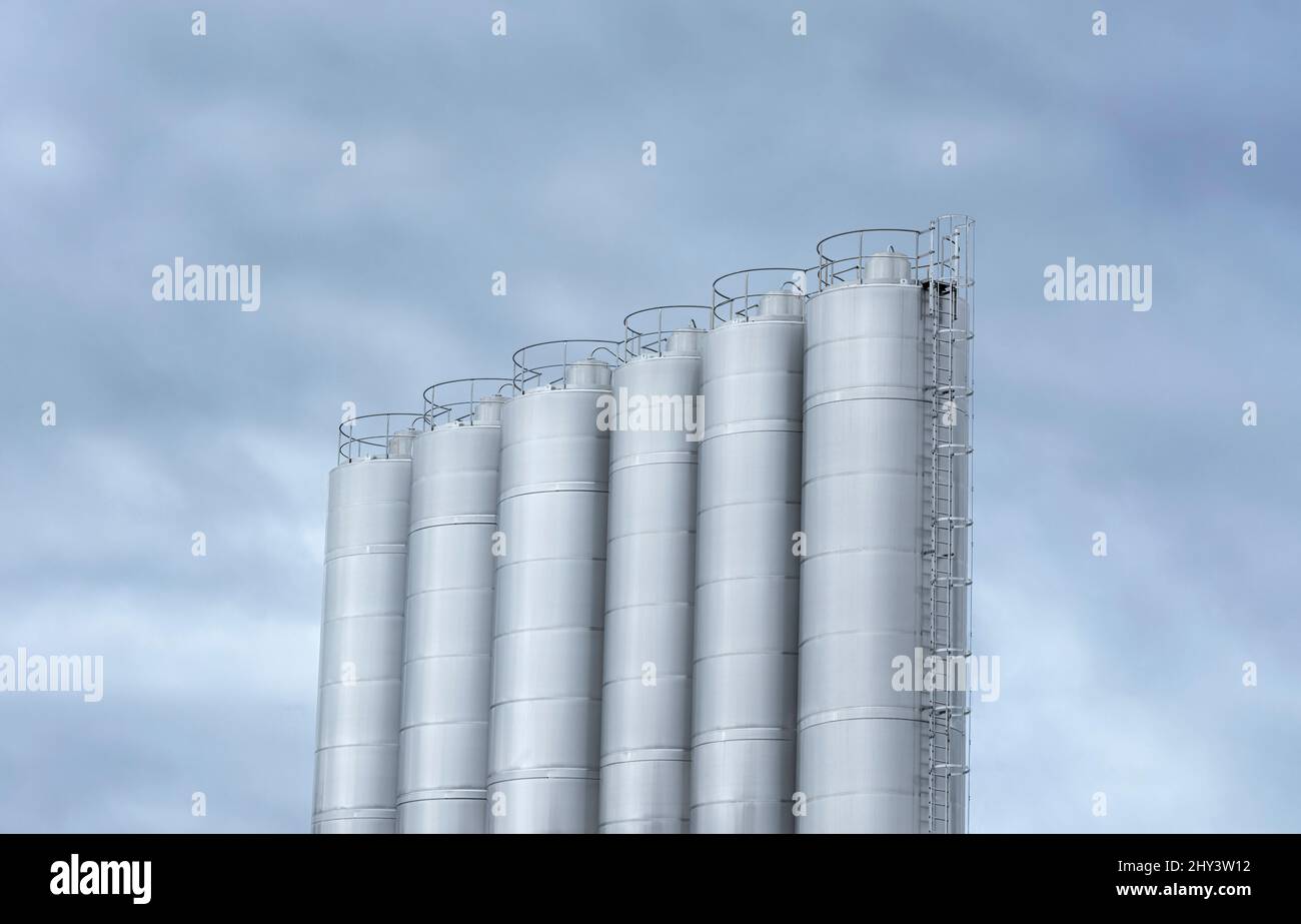 Stainless steel milk tanks at a modern dairy farm. Large storage tanks used in the beverage