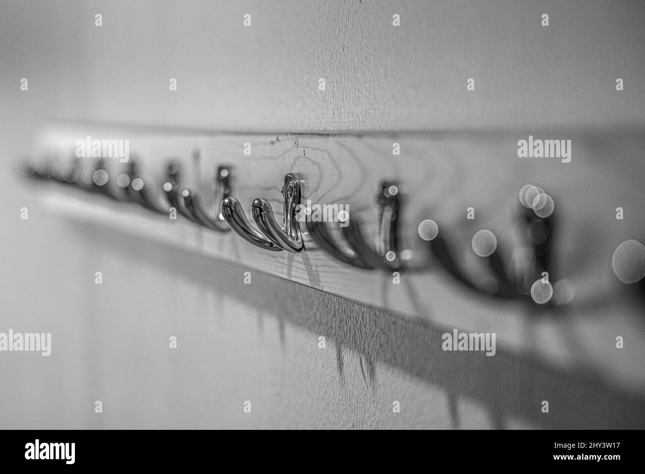 Grayscale closeup of the metal coat hooks. Selected focus Stock Photo ...