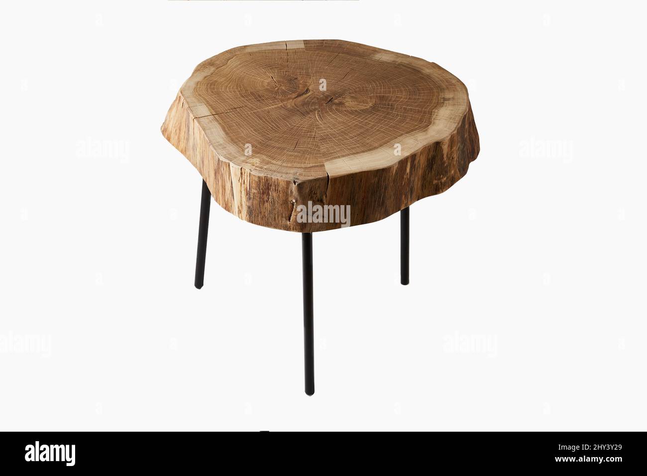Shot of a three legged stool made of wood trunk and steel isolated on a white background Stock Photo