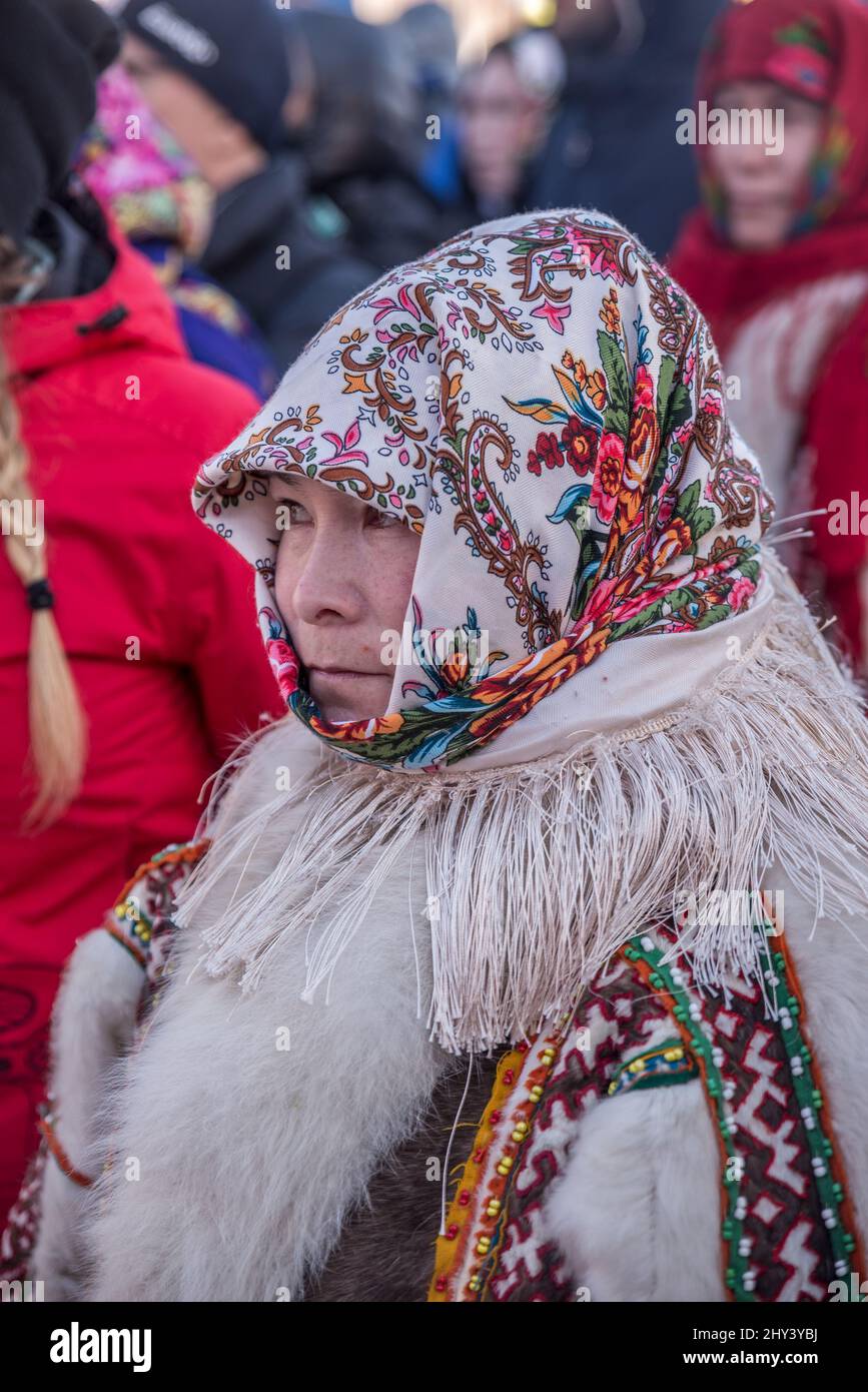 Young woman with colorful headscarf and traditional reindeer fur wear ...