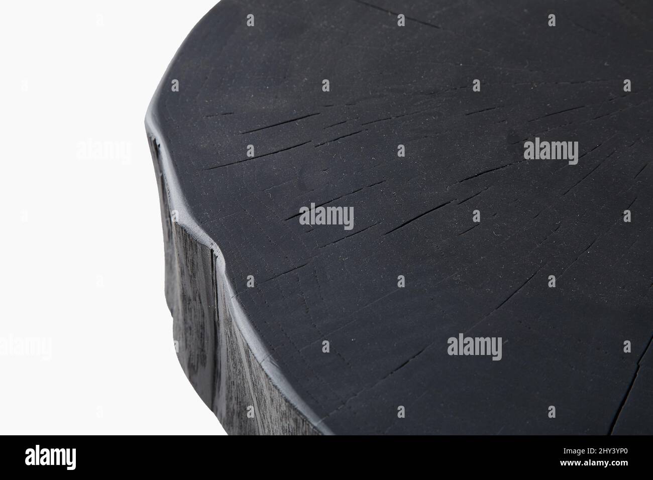 Close-up shot of the top of three legged black stool isolated on a white background Stock Photo