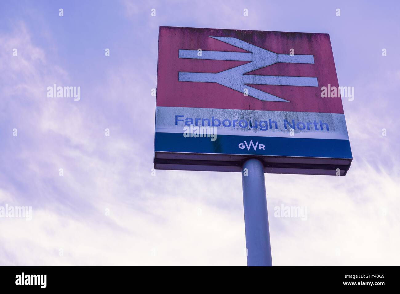 Low angle shot of a Farnborough North train station sign with cloudy