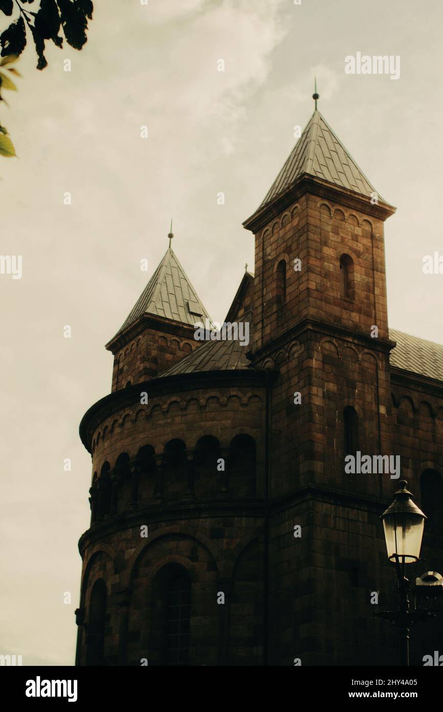 A vertical shot of Viborg Cathedral in Viborg, Denmark on cloudy sky background Stock Photo