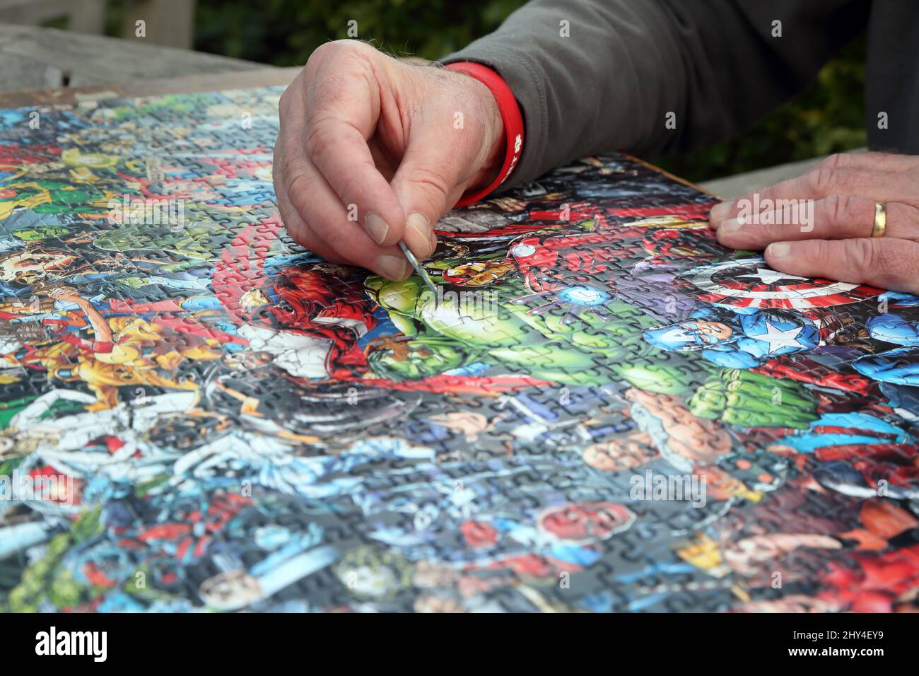 Man Doing a Marvel 1000 Piece Impossible Puzzle Stock Photo