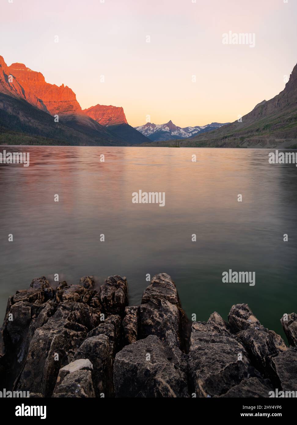 Vertical shot of a lake with mountains in the background Stock Photo ...