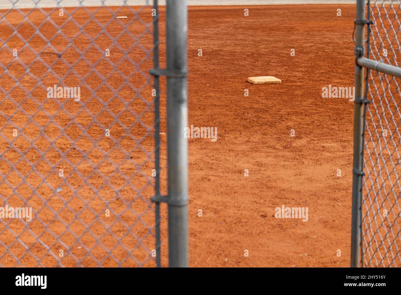Open gate to a brown baseball field Stock Photo Alamy