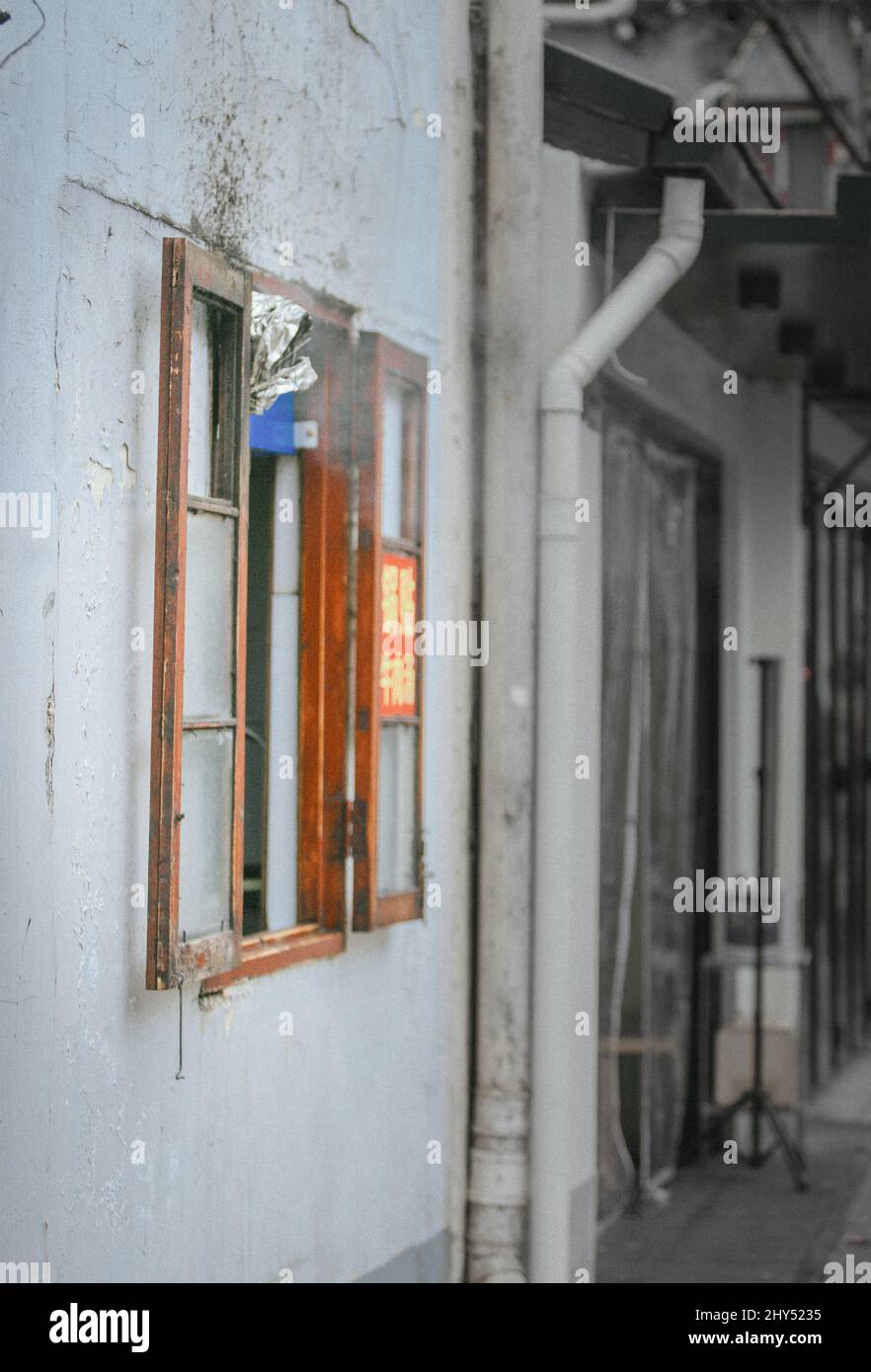 Shot of an old wooden window and tubes on a building Stock Photo - Alamy