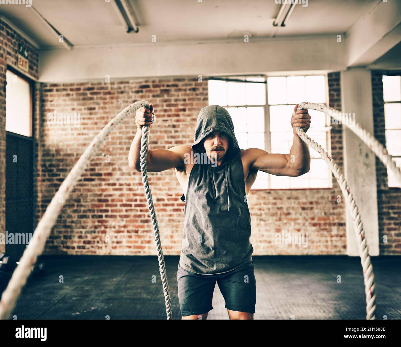 Ropes arent just for tying things. Shot of a hooded and determined ...