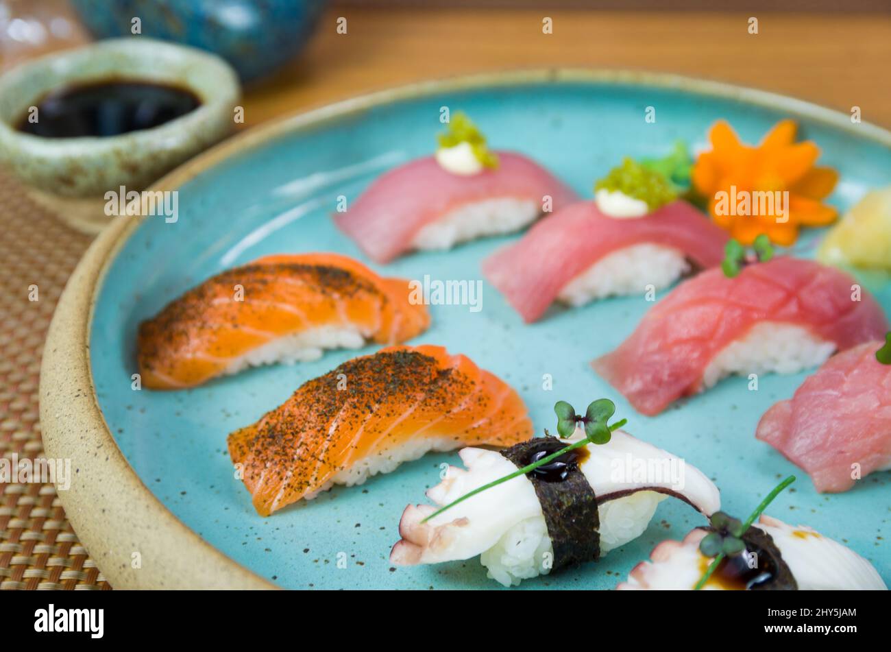 Assorted premium tuna and salmon nigiri sushi on a beautifully decorated plate. Stock Photo