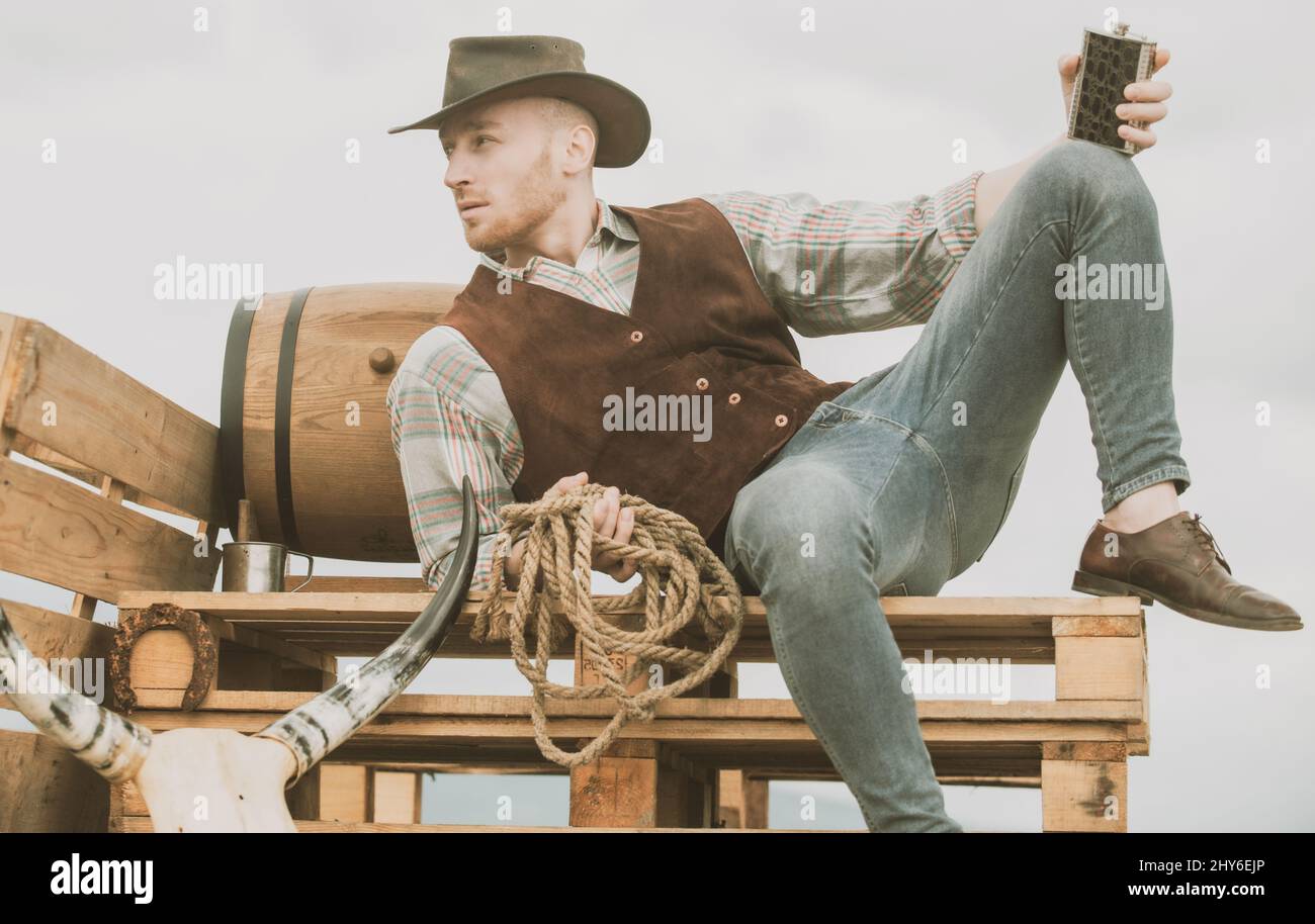 Cowboy on ranch. Handsome man in cowboy hat and retro vintage outfit ...