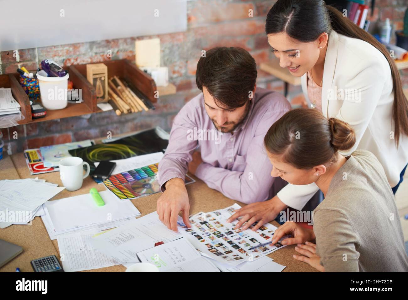 Moving forward on their next campaigne. Young creative professionals working in an office. Stock Photo