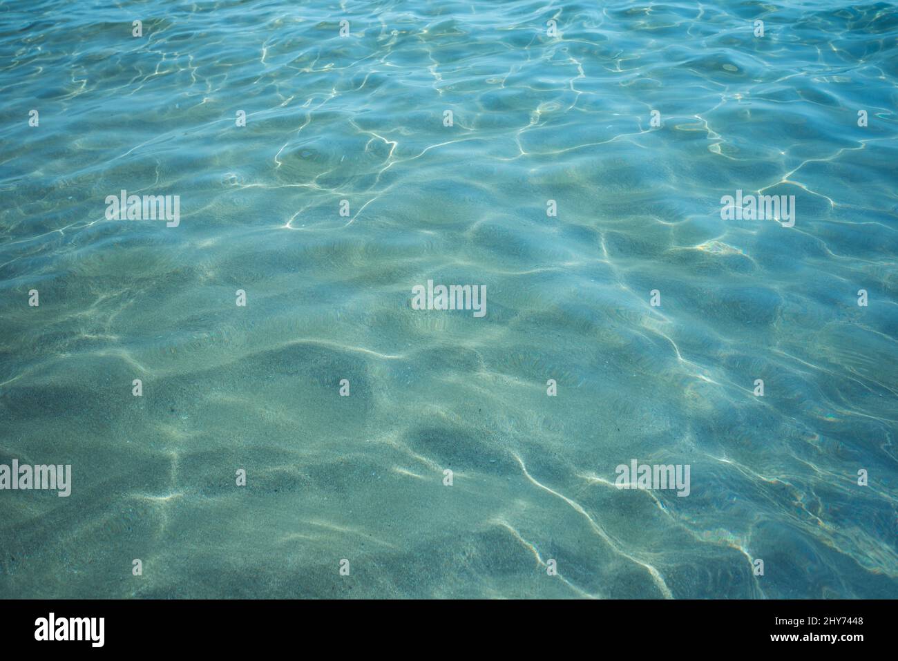 Background shot of aqua sea water surface with sun reflections Stock Photo