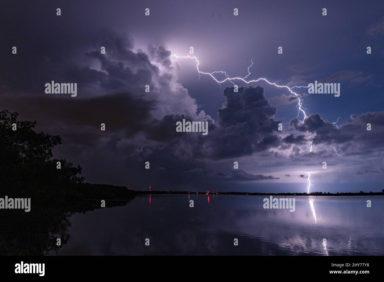 Stormy purple sky with striking lightning over water in Florida Stock ...