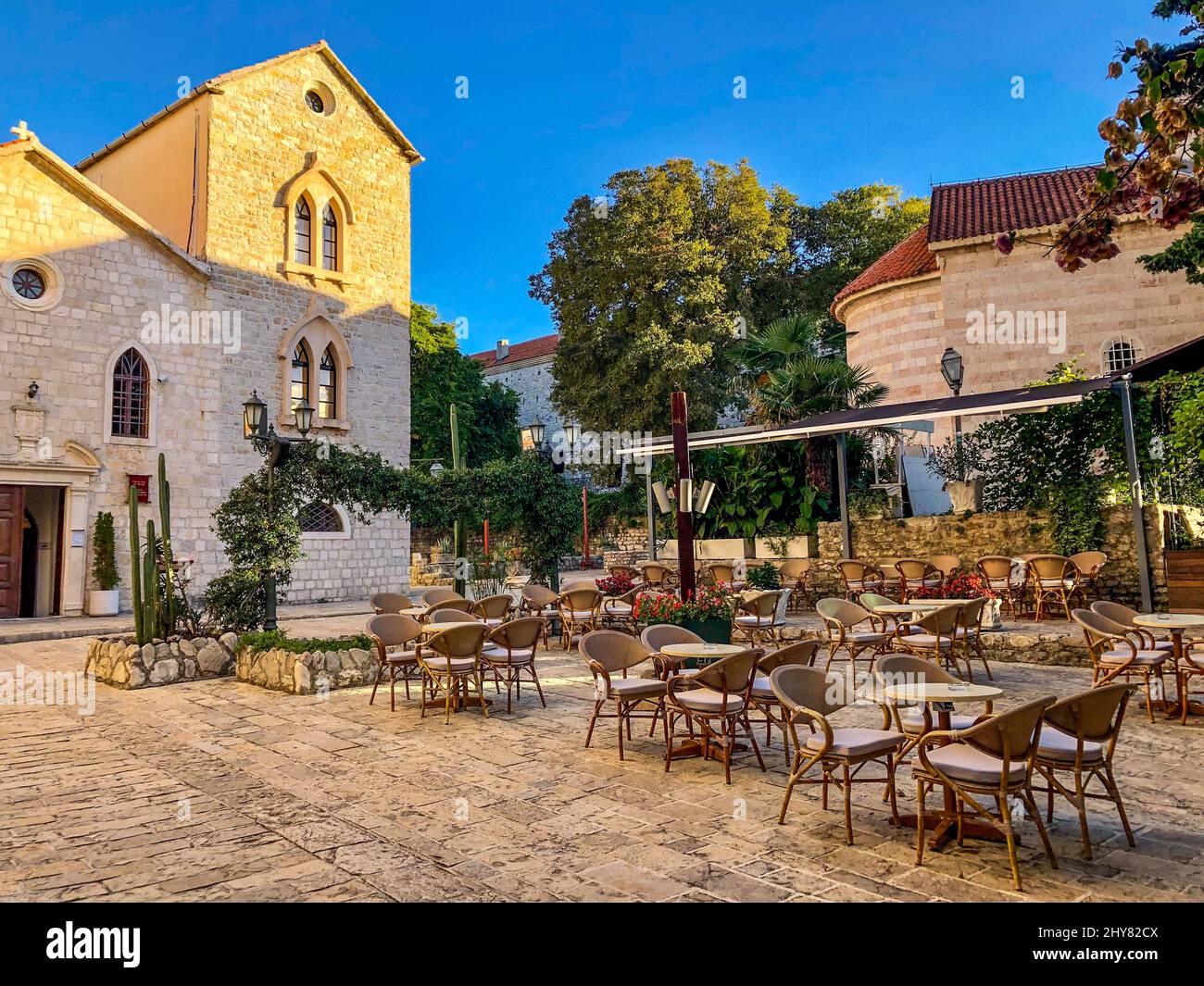 Beautiful shot of an outdoor cafe in front of the old catholic church