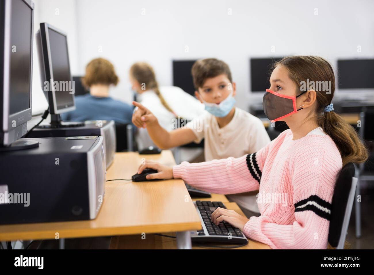 Preteen boy and girl in protective mask learn to solve problems on ...