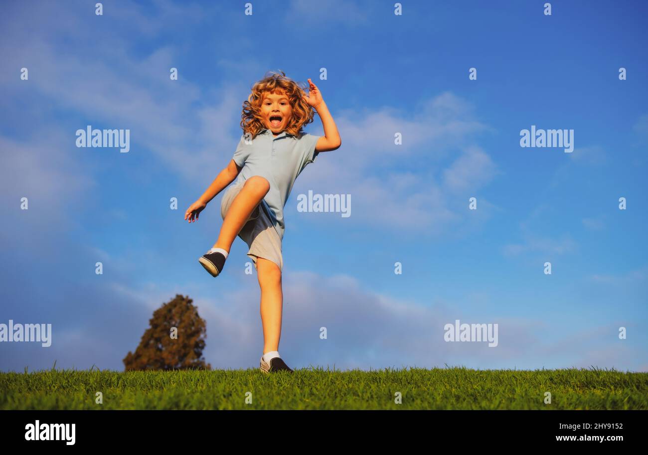 Smiling Running Around Caucasian boy in a park running and smiling. Happy kid laughing ...