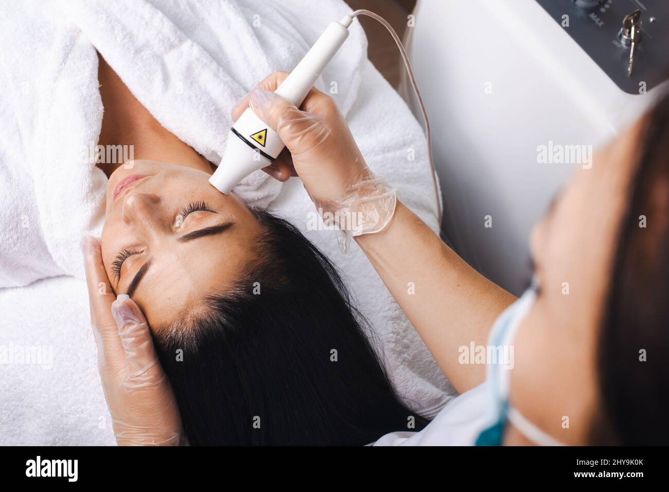 Beautician Making A Rejuvenating Facial Massage For The Woman In A Beauty Salon Lpg Apparatus